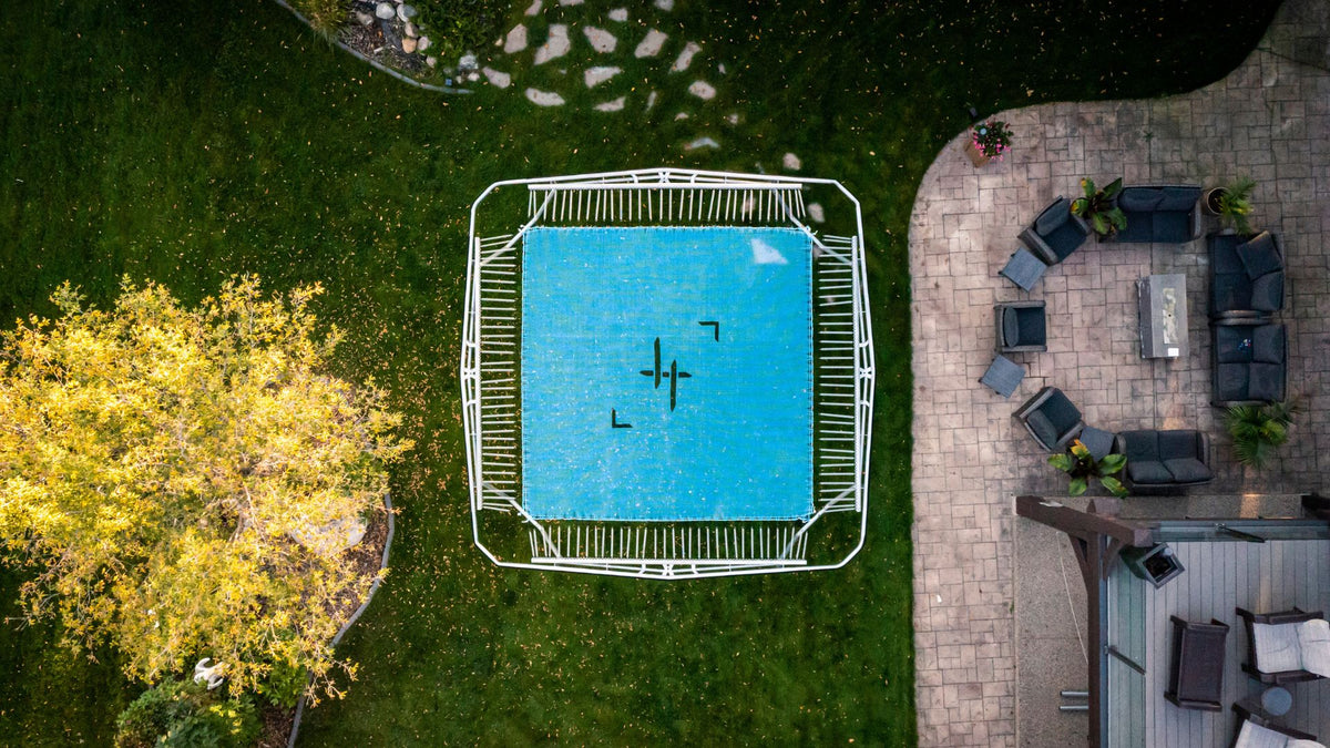 Aerial view of a trampoline with patio furniture and outdoor area