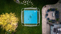 Aerial view of a trampoline with patio furniture and outdoor area