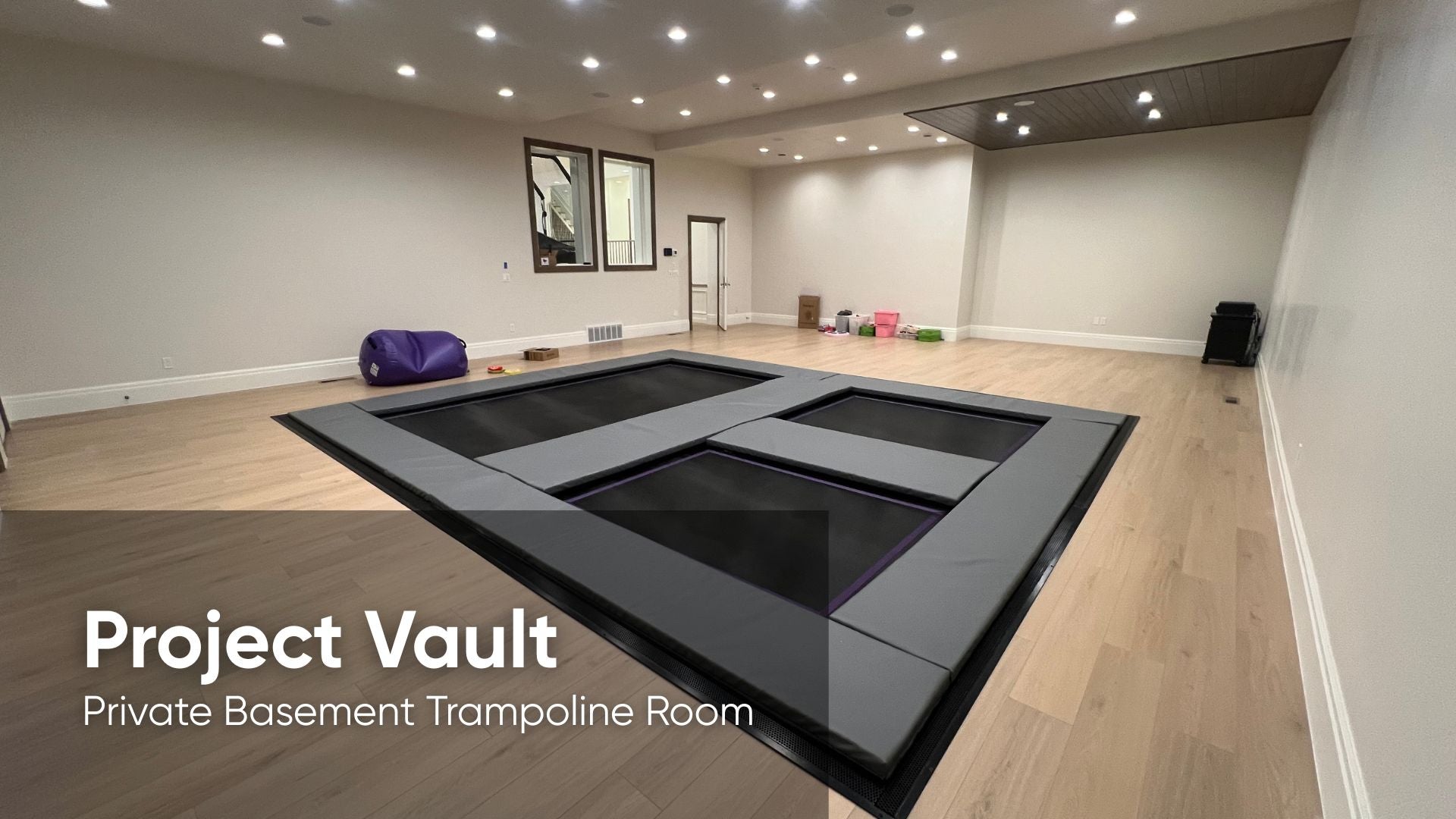 Private basement trampoline room with 'Project Vault' branding.